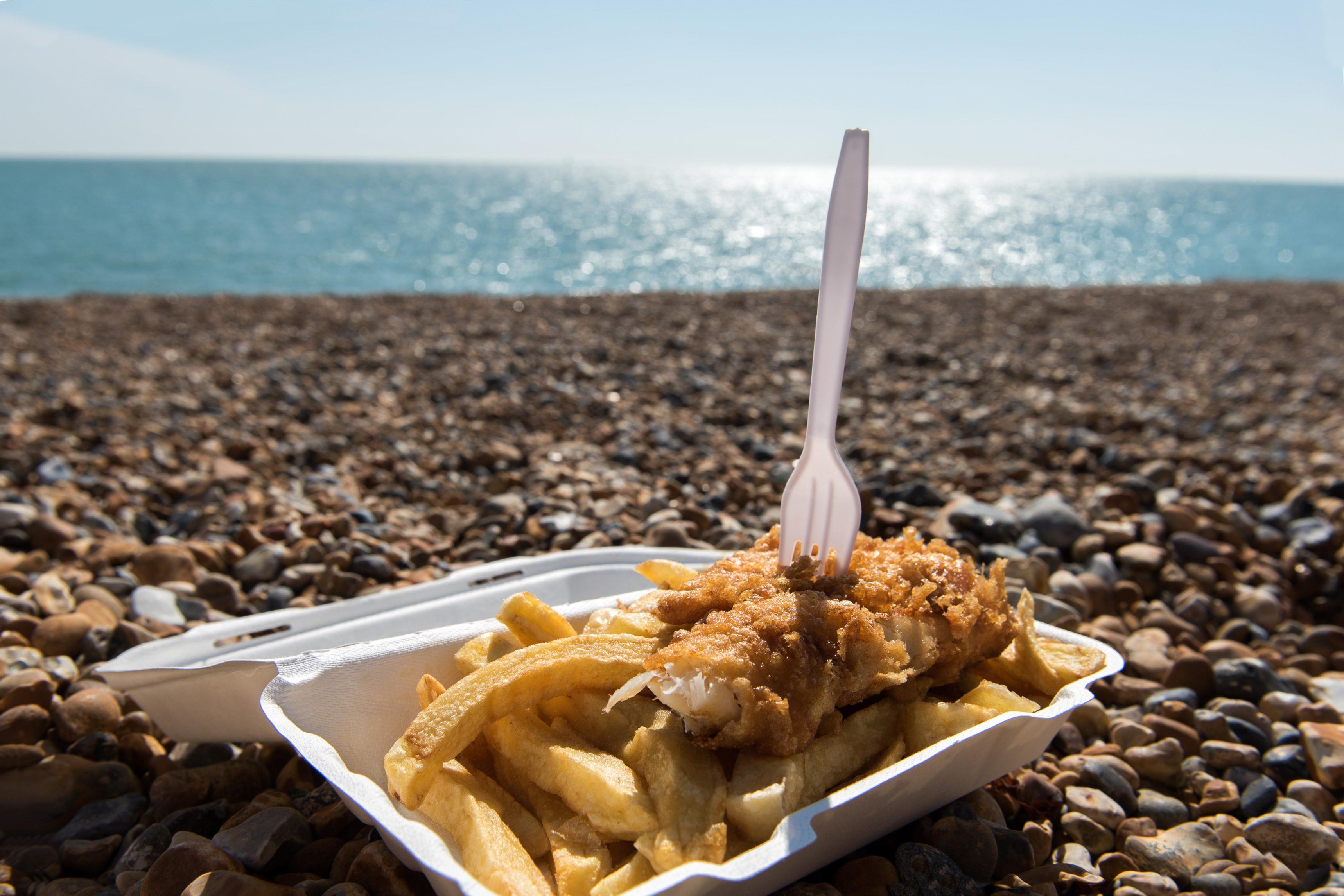 Delicious fish and Chips take away meal enjoyed on the beach | Brighton Zip